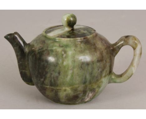 A CHINESE JADE LIKE HARDSTONE TEAPOT & COVER, the predominantly green stone with lighter and darker striations, 5.75in long i