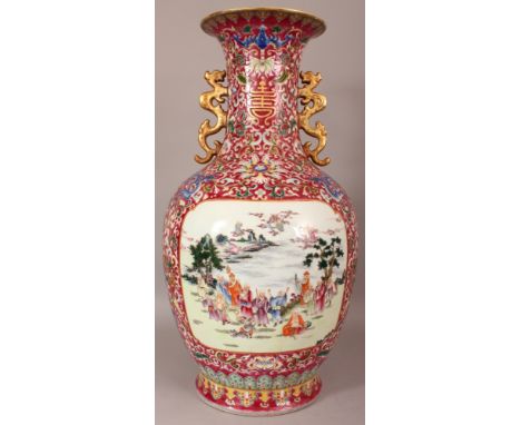 A LARGE CHINESE RUBY GROUND FAMILLE ROSE PORCELAIN VASE, decorated with detailed panels of Immortals in river landscape setti