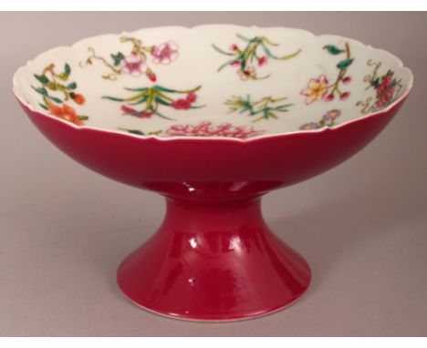 A CHINESE FAMILLE ROSE RUBY BACK PORCELAIN STEM BOWL, the interior decorated with floral sprays, the interior of the foot wit