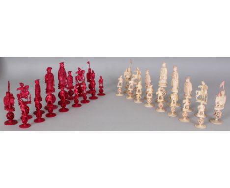 A 19TH CENTURY CHINESE CANTON IVORY SECTIONAL CHESS SET, one side stained red, the natural side including a Queen Charlotte p