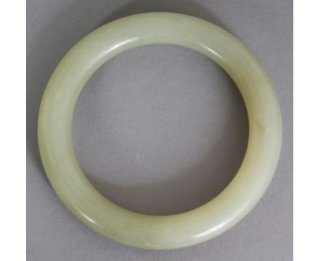 A GOOD QUALITY CHINESE CELADON JADE BANGLE, possibly 19th Century, 3.2in diameter, the inner rim 2.2in diameter.