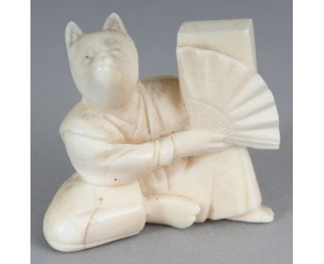 AN EARLY 20TH CENTURY JAPANESE IVORY NETSUKE OF A SEATED FOX, unsigned, the fox holding a fan, 1.25in wide at widest point & 