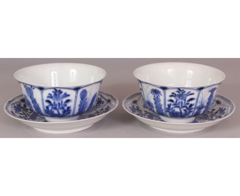 A PAIR OF 19TH CENTURY CHINESE BLUE & WHITE PORCELAIN BOWLS & SAUCERS, each piece painted with lappet panels of seasonal flow