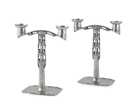 ARCHIBALD KNOX (1864–1933) FOR LIBERTY &amp; CO., LONDON PAIR OF 'TUDRIC' CANDELABRA, CIRCA 1904 pewter, stamped MADE BY LIBE