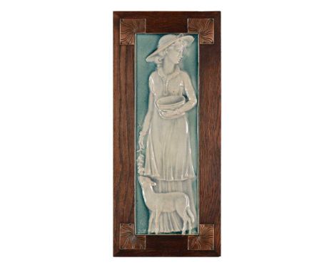 ENGLISH TILE PANEL, CIRCA 1900 glazed ceramic, with tube-lined monogram, the oak frame with copper plaques to the anglesDimen