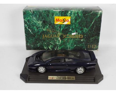 Maisto - A boxed diecast 1:12 scale Maisto #33201 1992 Jaguar XJ220. The model appears to be in Good overall dusty condition 