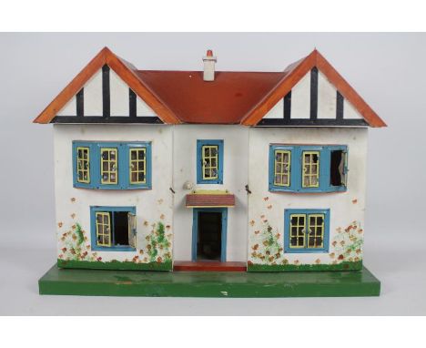 Triang - A wooden Dolls House possibly by Triang together with contents . The wooden twin eaved house features lighting, tinp