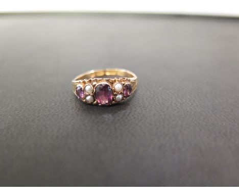 A 15ct gold amethyst and seed pearl dress ring - Hallmarked Birmingham, 1871 - Ring size K 1/2 - Weight approx 1.7gms
Conditi