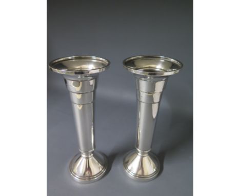 A pair of Walker and Hall trumpet shaped silver vases with turned decoration on weighted bases, Sheffield 1959, Height 20cm 
