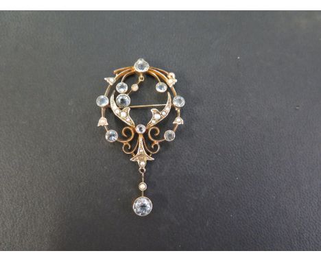An aquamarine and seed pearl pendant-brooch  - Of openwork scroll design - Stamped 9ct - Length 5.5cms - Weight approx 5.0gms