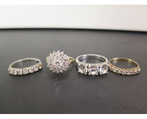 Four white-gem-set rings - Two with 9ct gold hallmarks - Ring sizes N and P - Weight approx 4.6gms - Together with two furthe