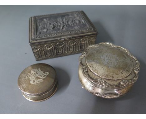 A George V circular silver ring box with floral decoration and incised initials to lid on hoof feet, an Edwardian silver circ