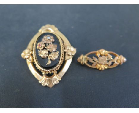 Two brooches - To include a foliate bar brooch - Width 3.5cms - Stamped 9ct - Together with an onyx, seed pearl and ruby broo