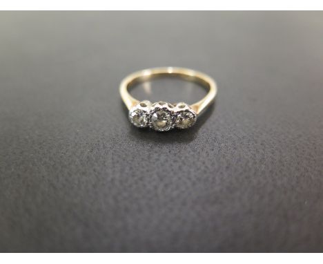A transitional-cut diamond three-stone ring - Estimated total diamond weight 0.30ct - Stamped 18ct and plat - Ring size L 1/2