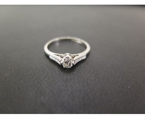 A brilliant-cut diamond single-stone ring - To the textured shoulders and plain band - Stamped platinum - Ring size N - Weigh