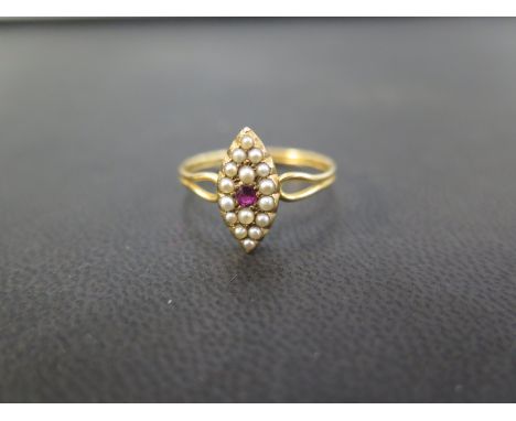 A ruby and seed pearl cluster ring - To the bifurcated shoulders and grooved band  Stamped 18 - Ring size R - Weight approx 2