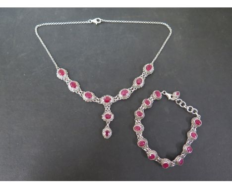 A set of ruby jewellery - To include a panel bracelet and a matching necklace - With marks indicating silver - Length of brac