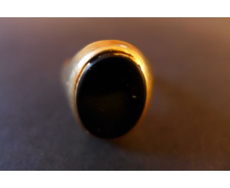 A yellow metal signet ring with oval onyx stone. Unmarked, tests as high carat - Ring size R- Total weight approx 9.3gms 
Con
