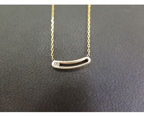 A 'floating' diamond necklace - Designed as an openwork curved panel containing a sliding brilliant-cut diamond to the belche