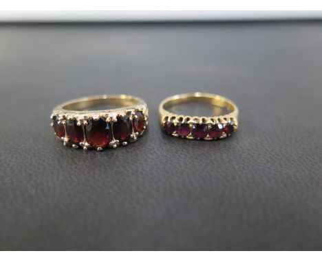 Two graduated garnet five-stone rings - One stamped 18ct, ring size O - Weight approx 3.3gms - One hallmarked 9ct, ring size 