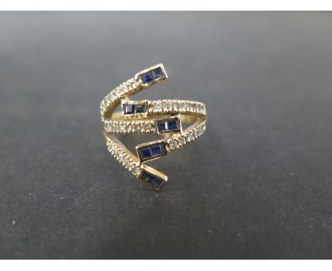 A sapphire and diamond openwork abstract dress ring - Stamped 14K - Ring size O 1/2 - Weight approx 6.0gms
Condition Report: 