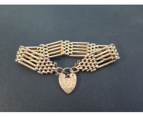 A textured five-bar gate bracelet - With decorative padlock clasp - Stamped 9ct - Length approx 19cms - Weight approx 27.9gms