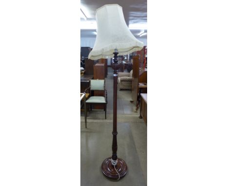 A carved mahogany standard lamp 