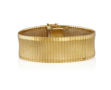 AN 18CT GOLD, OMEGA-LINK BRACELETWith wide, textured links and diagonally engraved decorative borders, total length ca. 19.5c