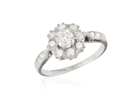 A DIAMOND CLUSTER RINGThe central, cushion-cut diamond ca. 0.52ct, bordered by eight old-cut diamonds, weight of old-cut diam