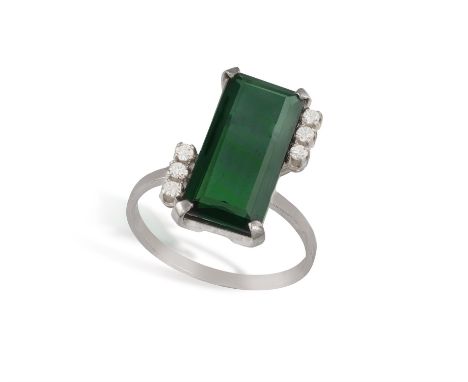 A GREEN TOURMALINE AND DIAMOND RINGThe rectangular step-cut green tourmaline flanked on each side by three, single-cut diamon