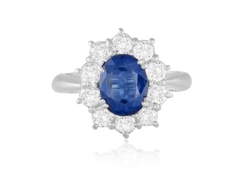 AN 18CT GOLD, SAPPHIRE AND DIAMOND CLUSTER RINGThe oval, mixed-cut sapphire, surrounded by ten round, brilliant-cut diamonds,