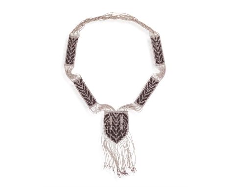 A GLASS BEAD SAUTOIR NECKLACEOf geometrical and tassel design, set throughout with purple and white facetted glass beads, inn