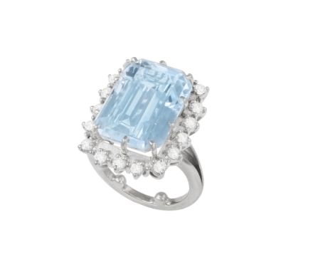 AN AQUAMARINE AND DIAMOND CLUSTER RINGThe step-cut aquamarine within round, brilliant-cut diamond surround, ring size L Condi
