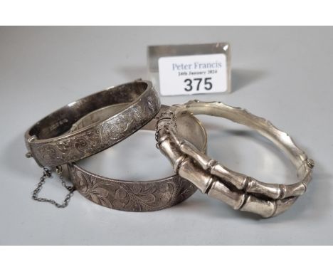 Collection of three silver bangles, one of simulated bamboo form in Japanese taste. 2.25 troy oz approx. (B.P. 21% + VAT)  Ba
