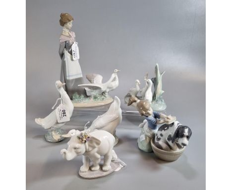 Three Lladro Spanish porcelain figurines to include: girl washing dog (with original box), an elephant and a lady with geese.