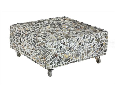 A contemporary Sassoft 'Akomena' pouffe, by Dilmos, silicon mounted with pebbles, on castors, 73cm square, 34cm high