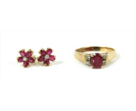 A gold ruby and diamond ring, with an oval mixed cut ruby, claw set with a pair of brilliant cut diamonds at each side, to ta