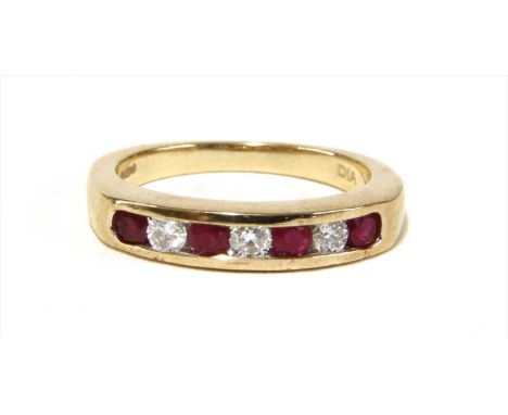 A 9ct gold ruby and diamond half eternity ring, with alternating brillant cut diamonds and circular mixed cut rubies, channel