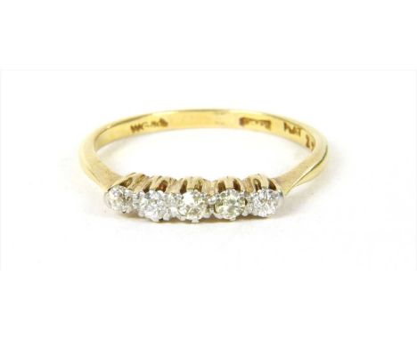 A gold five stone diamond ring, with a graduated row of old European and Swiss cut diamonds, claw set to tapering shoulders a