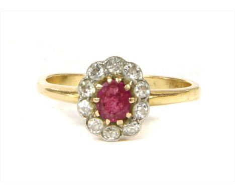 A gold ruby and diamond cluster ring, with an oval mixed cut ruby, claw set to surround of old eight cut and Swiss cut diamon