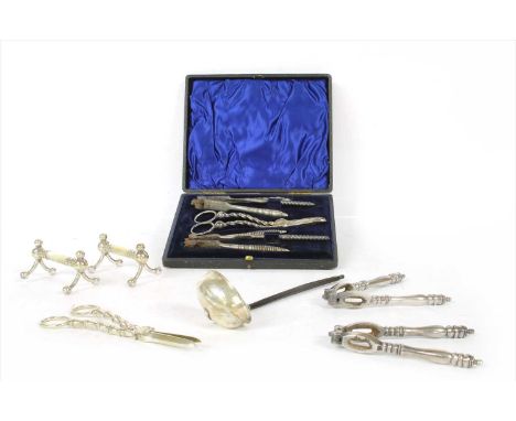A cased pair of mother-of-pearl watercress and grape scissors, plated knife rests, Georgian silver punch ladle, a pair of mat