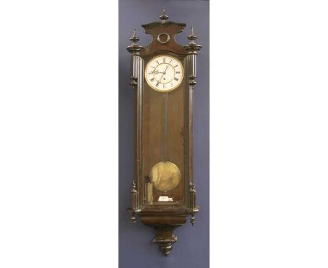 A mahogany Vienna regulator wall clock, with white enamel dial, black Roman numerals and turned finials, 125cm high