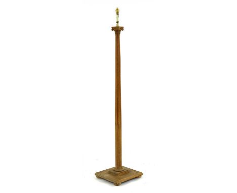 An oak standard lamp, in the manner of Heal's, with Ionic capital, stop fluted column and square base, 171cm high