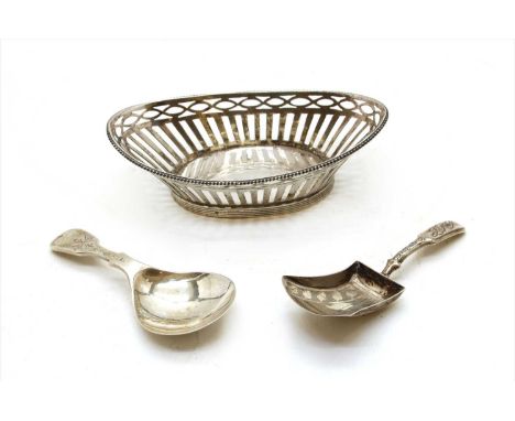 A Georgian silver caddy spoon, together with a silver miniature boat shaped basket, and a contemporary silver caddy spoon