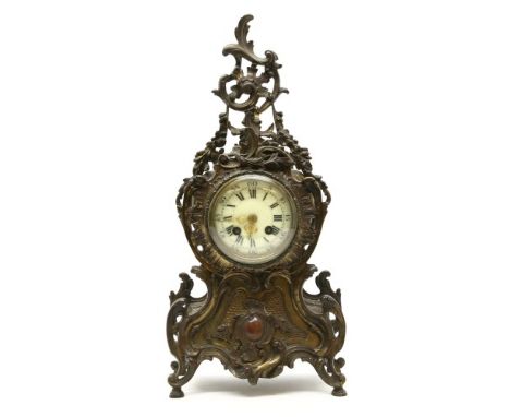 A 19th century French gilt metal mantel clock , the circular white enamel dial with Roman numerals within a pierced Rococo de