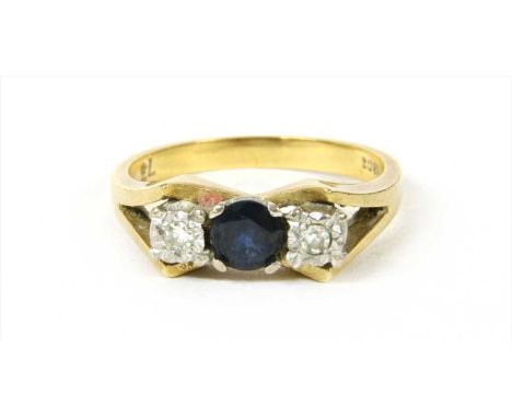 A gold sapphire and diamond ring, with a circular mixed cut sapphire, claw set with an eight cut diamond, grain set to an ill