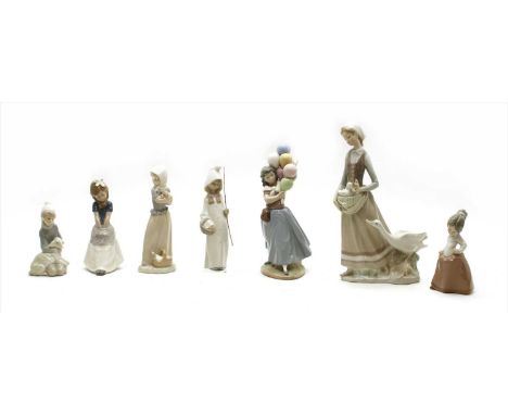 A collection of Lladro , Nao and similar figures, to include lady with geese, balloon seller, boy with lamb, etc