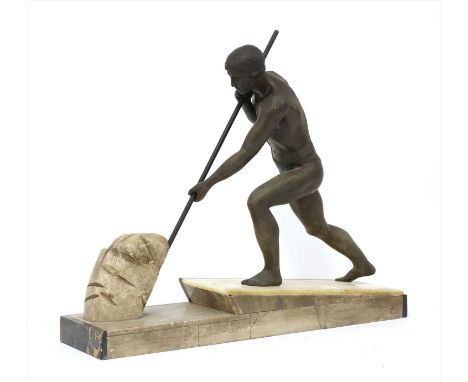 An Art Deco spelter centrepiece, modelled as a man moving a boulder, raised on a marble plinth, 53cm wide, 43cm high
