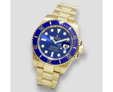 Rolex. An 18K gold automatic calendar bracelet watchModel: Oyster Perpetual SubmarinerReference: 116618Date: Purchased 27th J