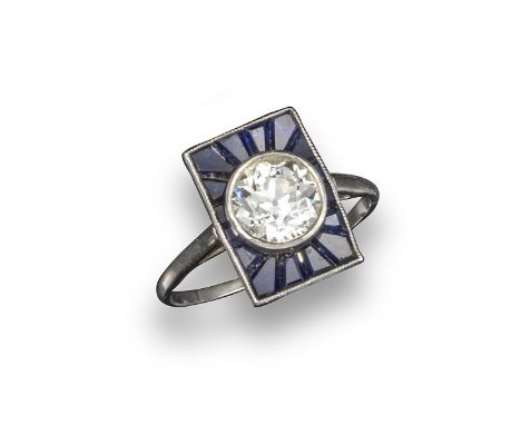 An Art Deco diamond and sapphire rectangular plaque ring, the old brilliant-cut diamond weighs approximately 1.40cts, rubover